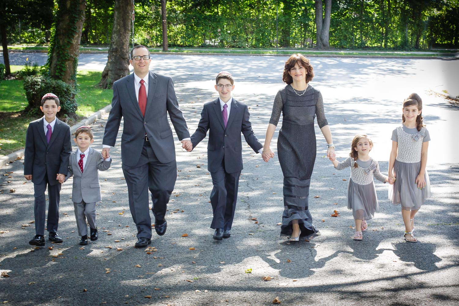 bar mitzvah and family walking on street